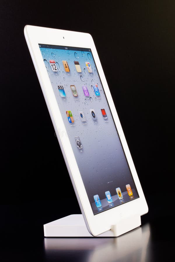 A white iPad 2 on the dock in black background. A white iPad 2 on the dock in black background.