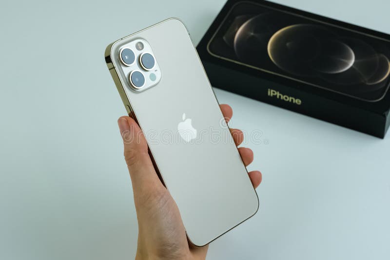 IPhone 12 Pro Max Gold in Hand of a Customer Editorial Photography