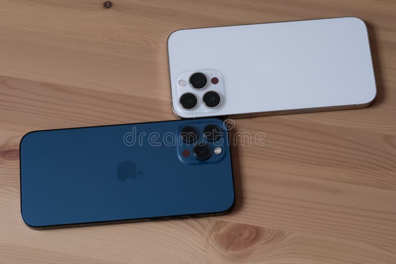 IPhone 13 Pro Max in Silver and IPhone 12 Pro Max in Pacific Blue. Editorial Stock Photo Image
