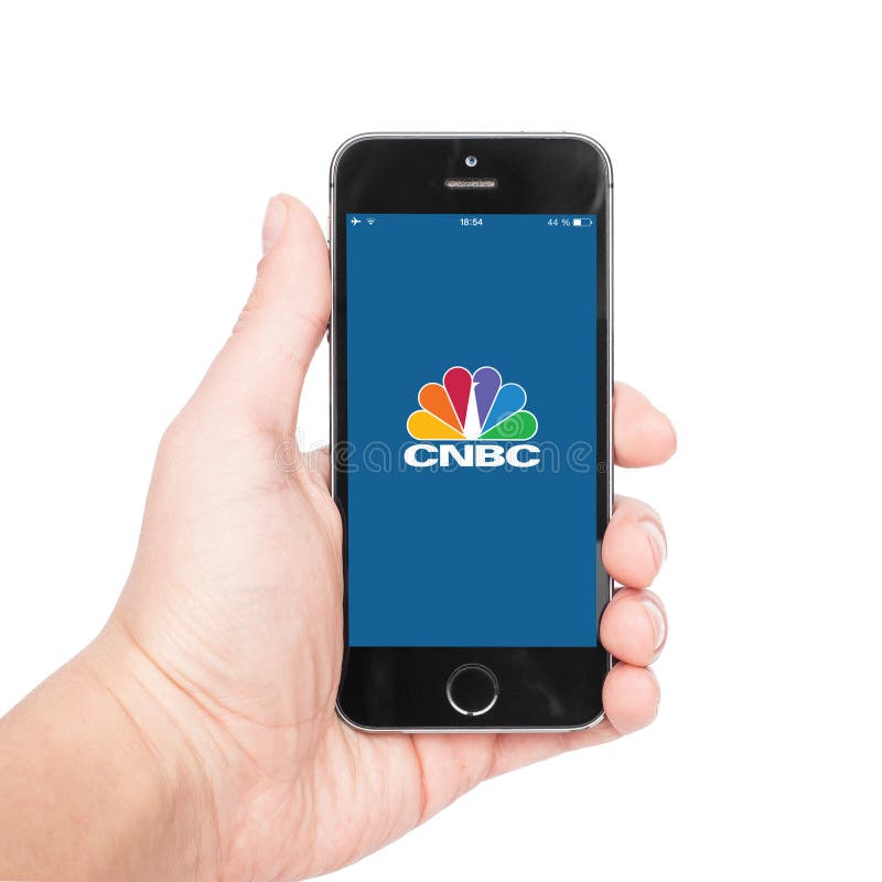 Pavlograd, Ukraine- December 22, 2014: Photo of a hand using CNBC app on iphone 5S. CNBC is an American basic cable and satellite business news television channel. Pavlograd, Ukraine- December 22, 2014: Photo of a hand using CNBC app on iphone 5S. CNBC is an American basic cable and satellite business news television channel