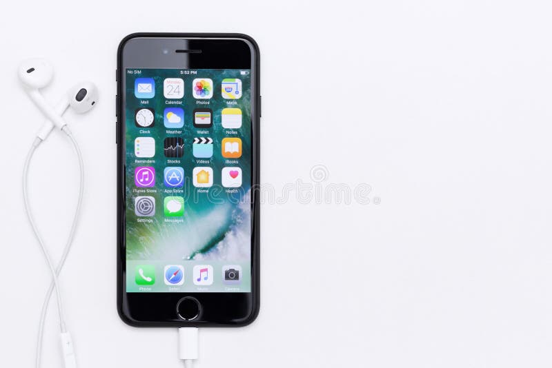 IPhone 7 screen showing application and earpods on white table