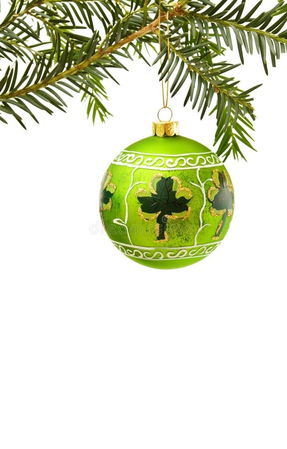 Celebrating Christmas in Ireland with traditional pine tree branch, green hand painted bauble and lucky shamrock. Isolated on white background. Celebrating Christmas in Ireland with traditional pine tree branch, green hand painted bauble and lucky shamrock. Isolated on white background.