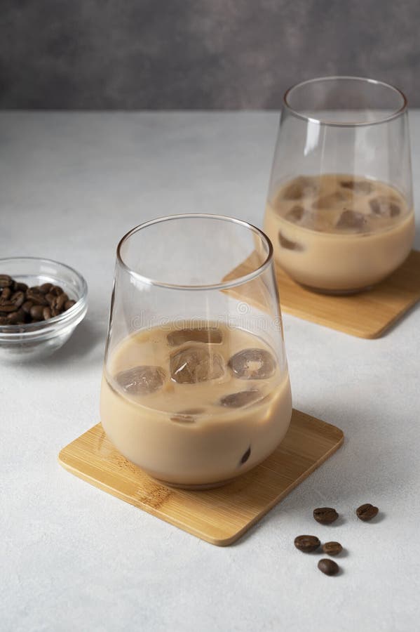 Irish Cream Liqueur in Two Glasses with Ice Cubes and Coffee Beans