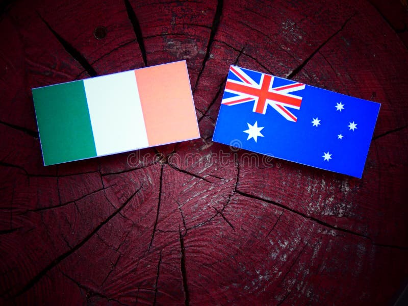 Irish Flag with Australian Flag on a Tree Stump Isolated Stock Photo