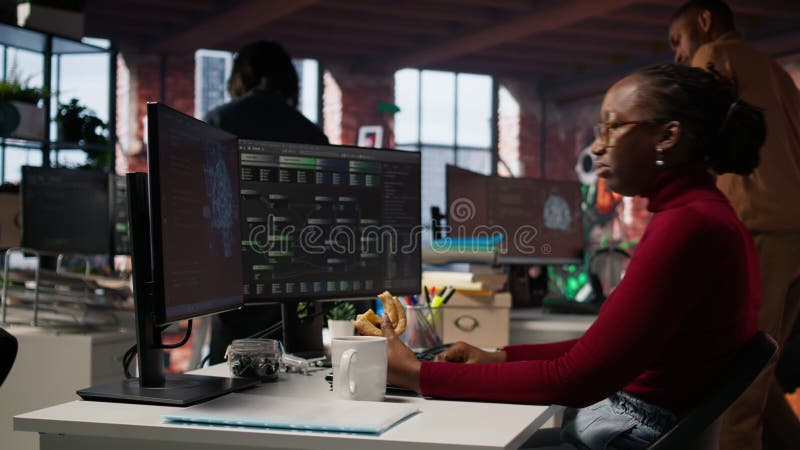 Irked AI startup engineer eating snack while waiting code to finish compiling stock video