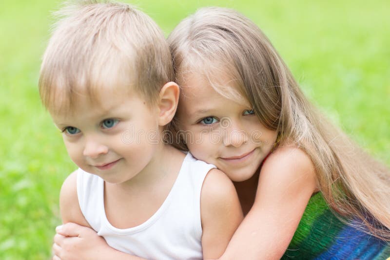 Older sister hugging little brother. Children three and seven years. Older sister hugging little brother. Children three and seven years.