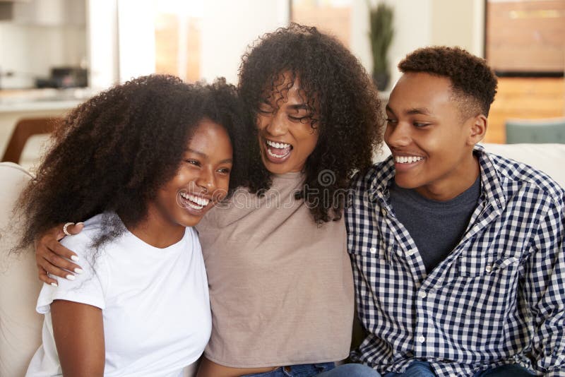 Black teen and young adult brother and sisters relaxing together, close up. Black teen and young adult brother and sisters relaxing together, close up