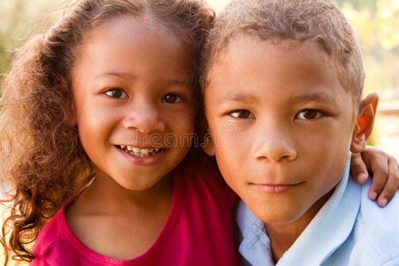 Mixed race brother and sister laughing and hugging. Mixed race brother and sister laughing and hugging.