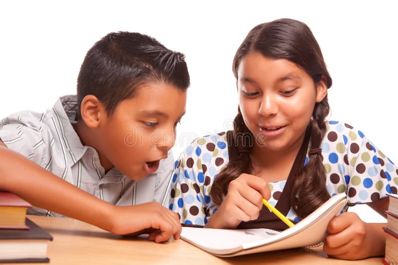 Hispanic Brother and Sister Having Fun Studying Together Isolated on a White Background. Hispanic Brother and Sister Having Fun Studying Together Isolated on a White Background.