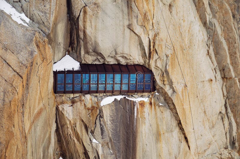 France, Chamonix-Mont-Blanc - October 12, 2019:  Iron construction with windows in Mount Aiguille du Midi for tourists and climbers. France, Chamonix-Mont-Blanc - October 12, 2019:  Iron construction with windows in Mount Aiguille du Midi for tourists and climbers