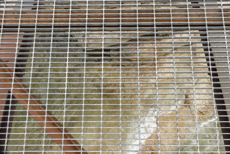 Iron grid of a bridge over a mountain river stock images