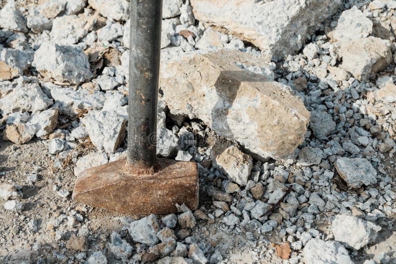 Iron Hammer Breaking Stone into Pieces. Large Sledgehammer for