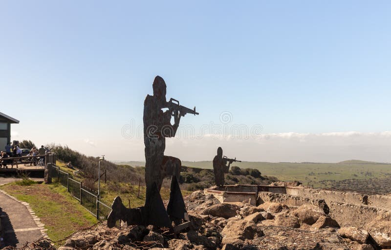 Iron silhouettes of soldiers with a gun, standing in a trench and looking into the distance, on Mount Bental in the Golan Heights in Israel