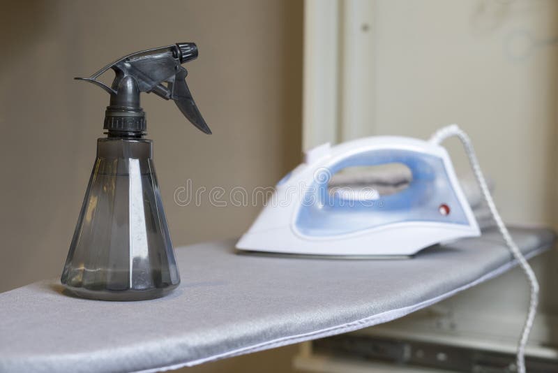 Iron and Spray Bottles on Table, Preparing To Ironing Cloth. Stock