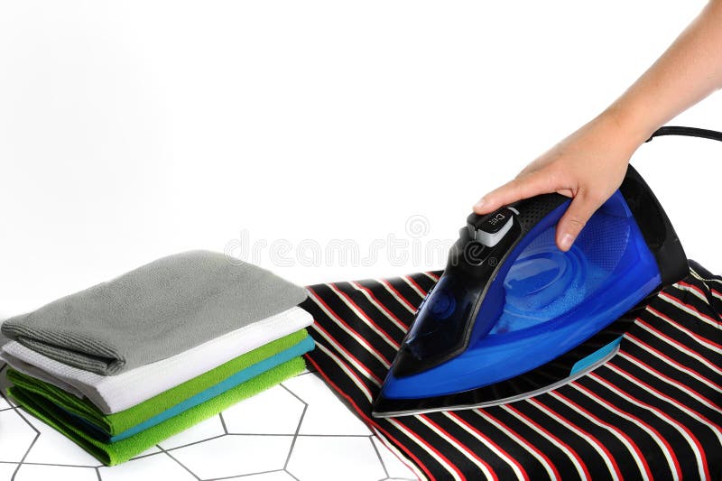 On the Ironing Board is Blue Iron Held by a Human Handand Stock Image
