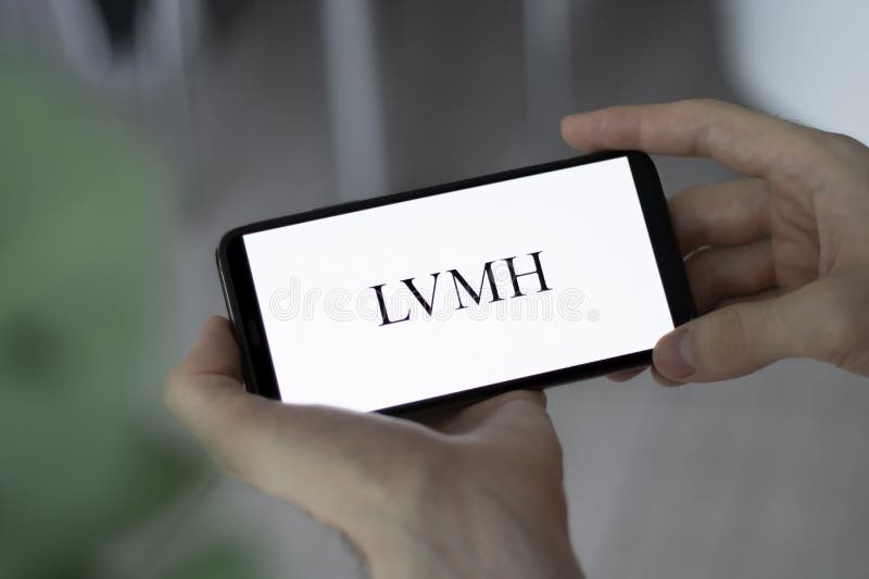 In this photo illustration a LVMH logo is seen on a smartphone and