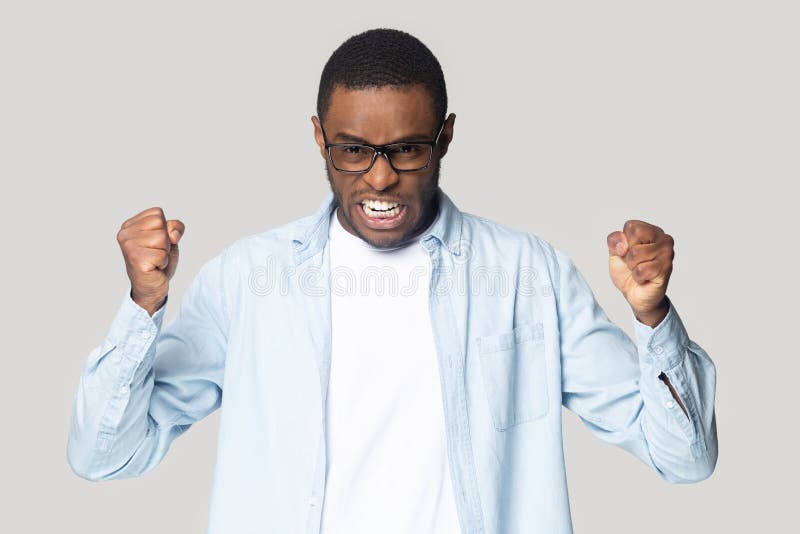 Irritated angry african american guy clenching both hands in fists. stock images Irritated angry african american guy clenching both hands in fists. stock images