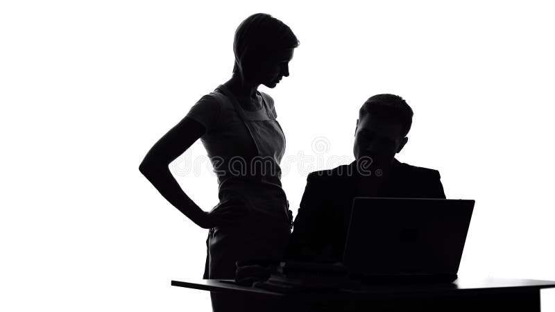 Irritated wife in apron looking at husband working on laptop, household duties royalty free stock photo Irritated wife in apron looking at husband working on laptop, household duties royalty free stock photo