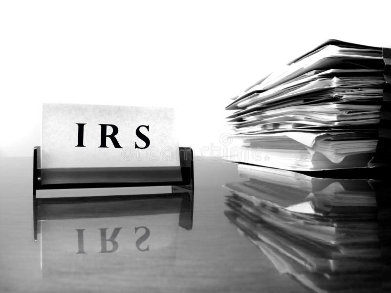 IRS Card on desck with tax files. IRS Card on desck with tax files