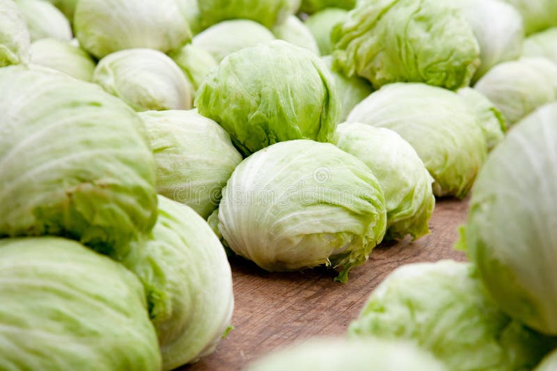 Iceberg lettuce on a market place. Soft diffused lighting a bit from behind. Soft reflexes. Iceberg lettuce on a market place. Soft diffused lighting a bit from behind. Soft reflexes.