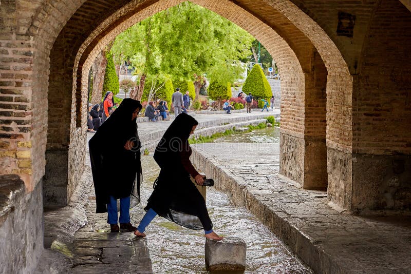 Young iranian women jump over water under bridge, Isfahan, Iran. royalty free stock images Young iranian women jump over water under bridge, Isfahan, Iran. royalty free stock images
