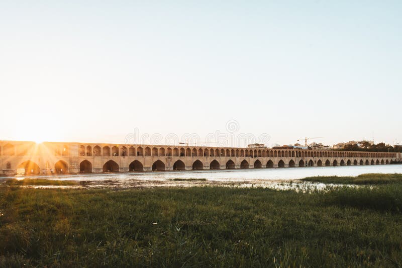 Isfahan, Iran - May 2022: SioSe Pol or Bridge of 33 arches, one of the oldest bridges of Esfahan and longest bridge on Zayandeh River. Isfahan, Iran - May 2022: SioSe Pol or Bridge of 33 arches, one of the oldest bridges of Esfahan and longest bridge on Zayandeh River.