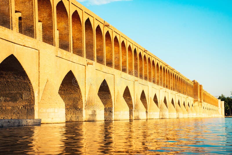 Isfahan, Iran - May 2022: SioSe Pol or Bridge of 33 arches, one of the oldest bridges of Esfahan and longest bridge on Zayandeh River. Isfahan, Iran - May 2022: SioSe Pol or Bridge of 33 arches, one of the oldest bridges of Esfahan and longest bridge on Zayandeh River.