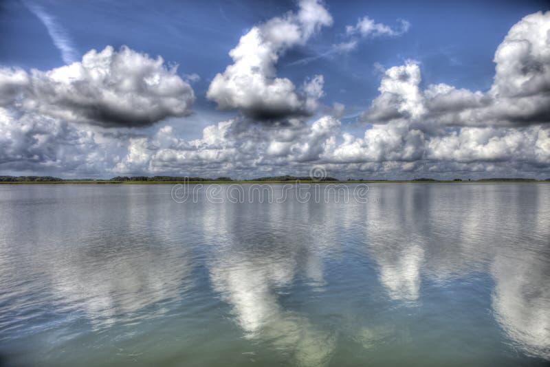 Hdr image of island, water, and blue sky with clouds. Contrast enhanced stock images, royalty-free photos and pictures