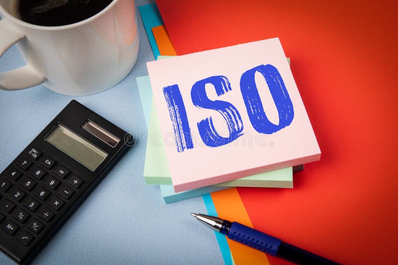 ISO. Notepad with text, coffee mug and calculator and stationery on office table royalty free stock photos
