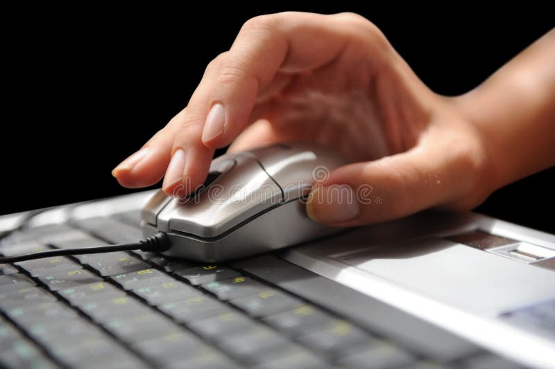 Isolate moves the computer mouse. Isolate of a woman s hand, which moves the computer mouse on the keyboard