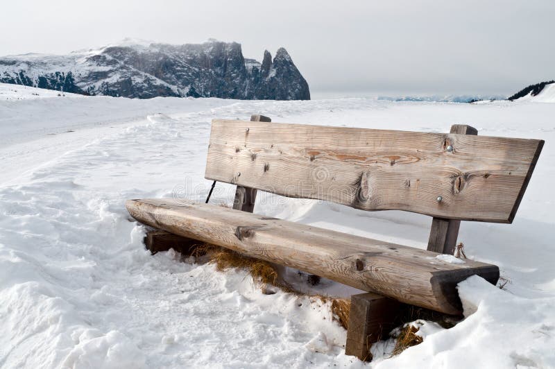 Isolated bench in snow scape