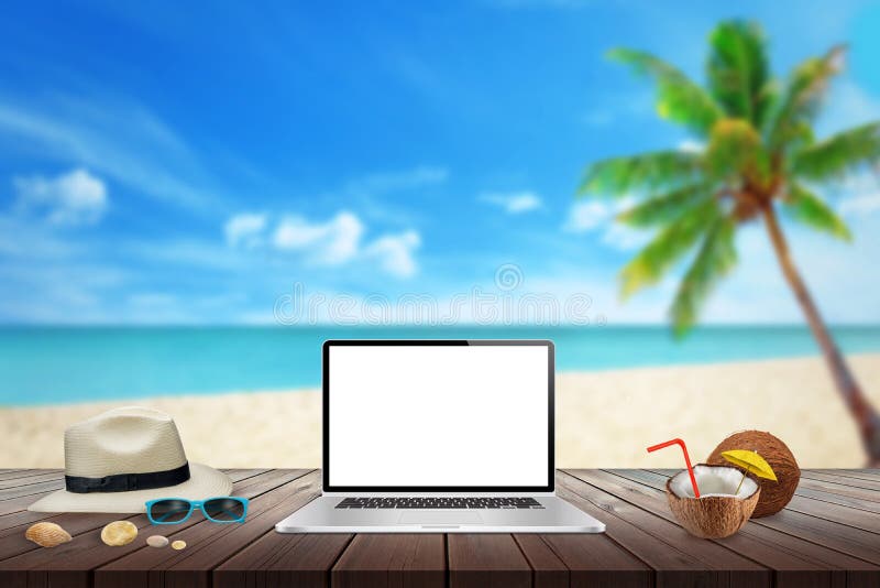 Isolated display of laptop on wooden table for mockup. Beach, sea, palm and blue sky in background.