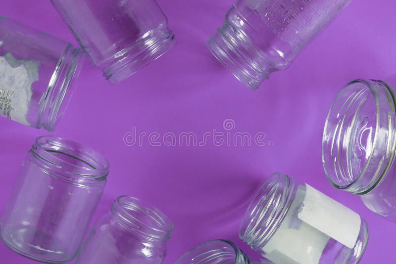 Isolated glass jars, no lids flat, violet purple background, copy space room royalty free stock photography Isolated glass jars, no lids flat, violet purple background, copy space room royalty free stock photography