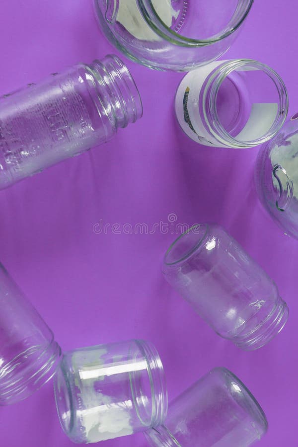 Isolated glass jars, no lids flat, violet purple background, copy space room royalty free stock photos Isolated glass jars, no lids flat, violet purple background, copy space room royalty free stock photos