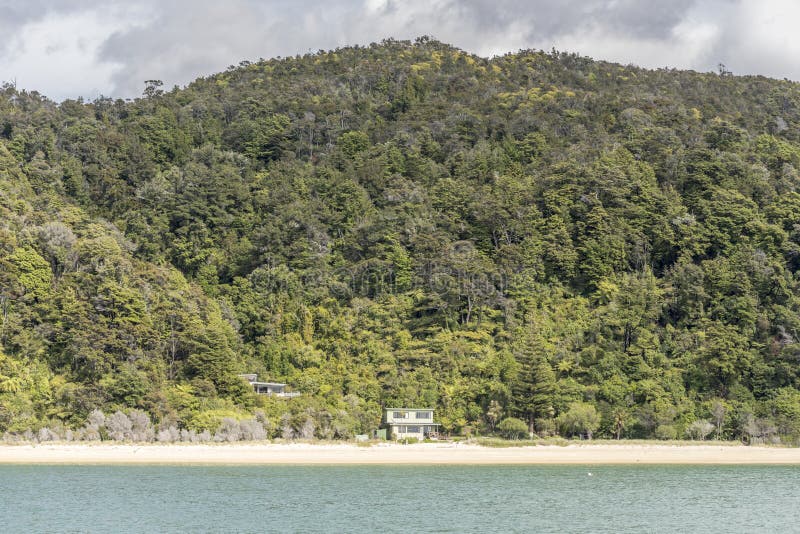 Isolated houses on sandy beach at Coquille bay, Abel Tasman park , New Zealand