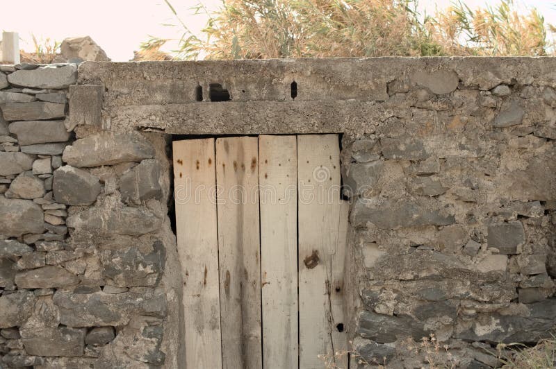 Isolated old wooden door in a stoned wall of a rural place Madeira, Portugal, Europe