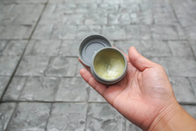 People hand hold setting wax product in for hair style stock photo