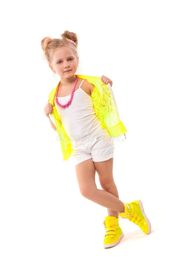 Pretty little girl in yellow shirt, white shorts and yellow boots
