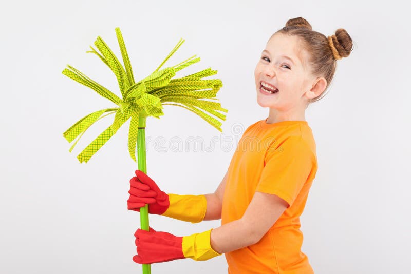 Cute little girl in gloves with a broom