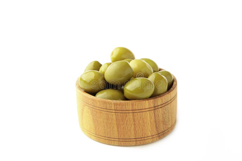 Isolated wooden bowl with green tinned olives