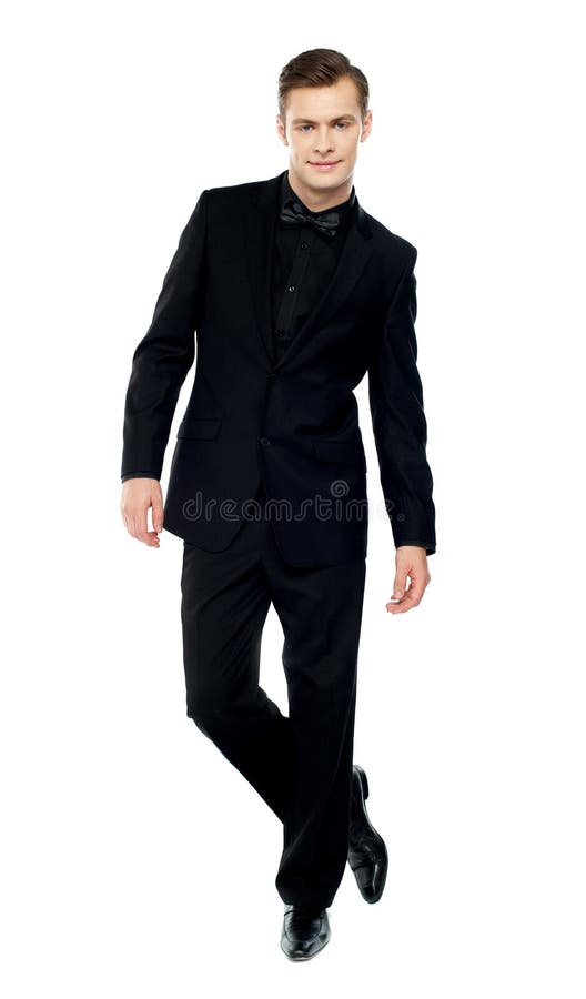 Isolated young man standing with crossed legs royalty free stock photos