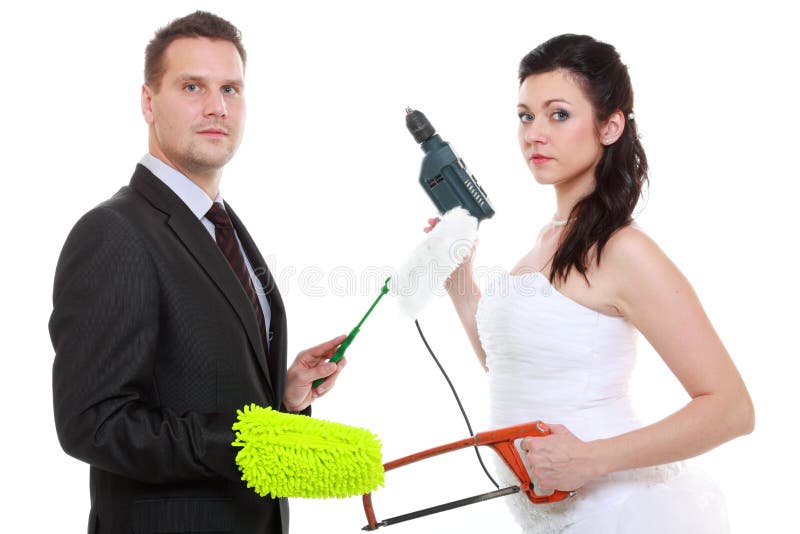 Feminism emancipation concept. Humorous funny couple bride groom in domestic role, sharing household chores. Woman with male tools, men with cleaning cloth isolated on white background. Feminism emancipation concept. Humorous funny couple bride groom in domestic role, sharing household chores. Woman with male tools, men with cleaning cloth isolated on white background