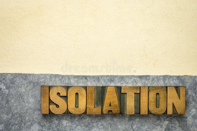 Isolation word abstract in vintage letterpress wood type and handmade bark paper, loneliness, social distancing or quarantine during coronavirus covid-19 pandemic concept. Isolation word abstract in vintage letterpress wood type and handmade bark paper, loneliness, social distancing or quarantine during coronavirus covid-19 pandemic concept