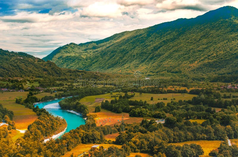 Isonzo Soca river valley yellow teal and orange sunset landscape in Slovenia - Italy border