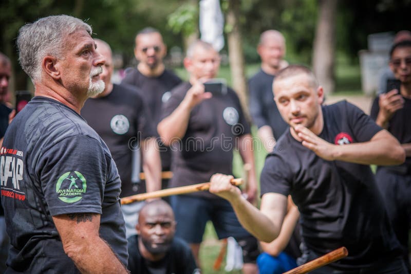 Large group of students practice filipino eskrima arnis stick