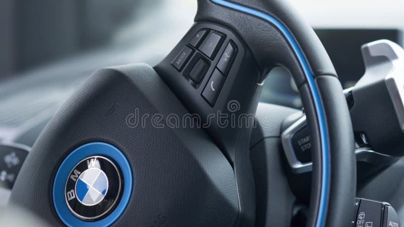 ISTANBUL, TURKEY, MAY 17, 2016: Steering wheel detail from BMW i3, a B-class, high-roof hatchback manufactured and marketed by BMW with an electric powertrain using rear wheel drive. ISTANBUL, TURKEY, MAY 17, 2016: Steering wheel detail from BMW i3, a B-class, high-roof hatchback manufactured and marketed by BMW with an electric powertrain using rear wheel drive.