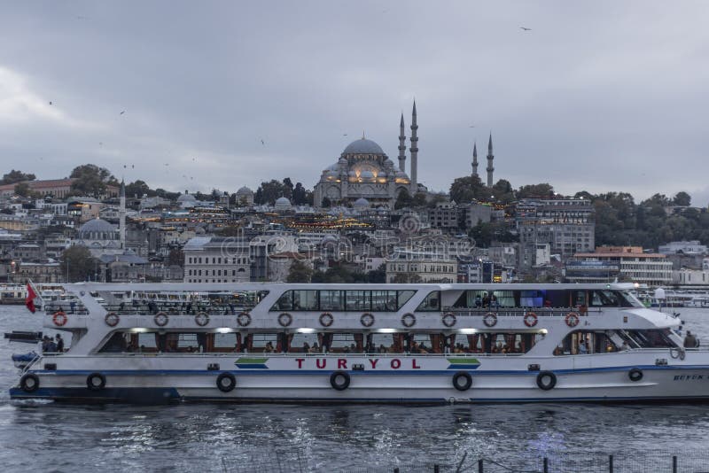 Suleymaniye Mosque and Eminonu coast in cloudy weather. Boats selling fried fish and people walking around. Photographed royalty free stock photo Suleymaniye Mosque and Eminonu coast in cloudy weather. Boats selling fried fish and people walking around. Photographed royalty free stock photo
