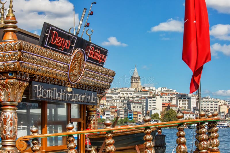 ISTANBUL, TURKEY - October 9th, 2019: View to Galata Tower from Eminonu pier across Bay of Golden Horn on sunny morning royalty free stock image ISTANBUL, TURKEY - October 9th, 2019: View to Galata Tower from Eminonu pier across Bay of Golden Horn on sunny morning royalty free stock image