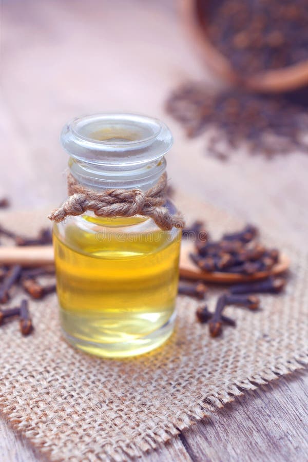Istotnego aromata goździkowy olej w szklanej butelce zdjęcia stock Istotnego aromata goździkowy olej w szklanej butelce zdjęcia stock