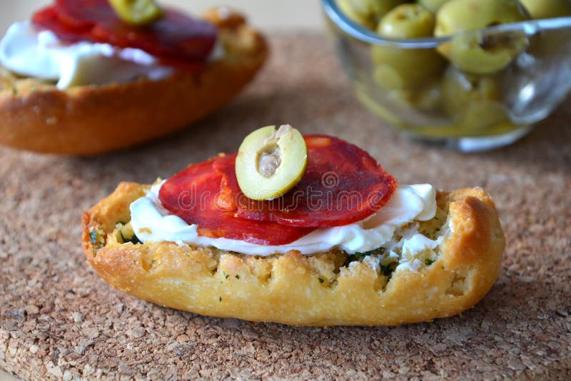 Italian bruschetta bread with salami and mozzarella on a plate